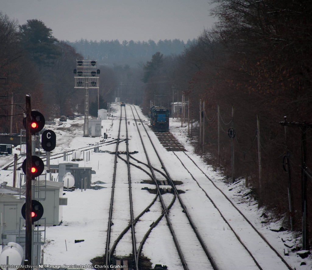 BERX 7535 sits on a siding while a hi-rail heads out.